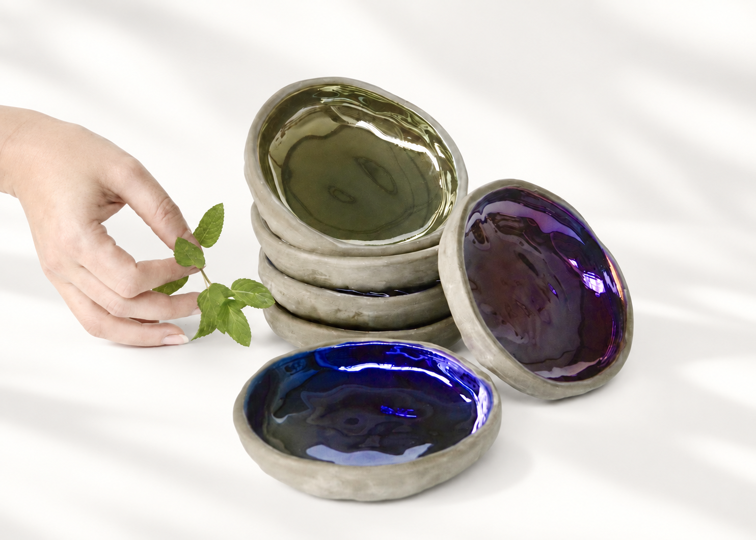Iridescent ceramic tasting dishes with mint